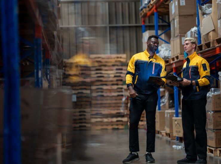 A team of engineers inspects the warehouse in a large storage warehouse.